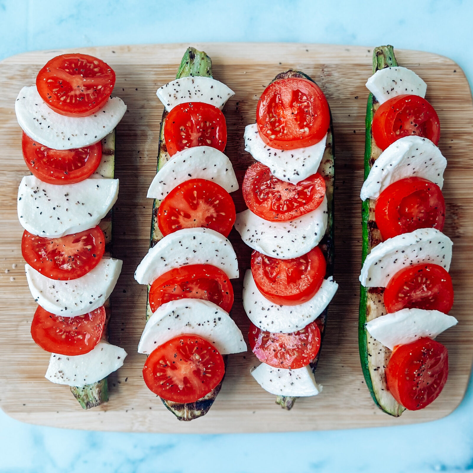 Grilled Caprese Zucchini Boats - Showit Blog